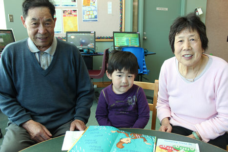 Alex reading with his grandparents