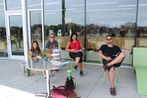 Family reading on Vellore Village Library patio