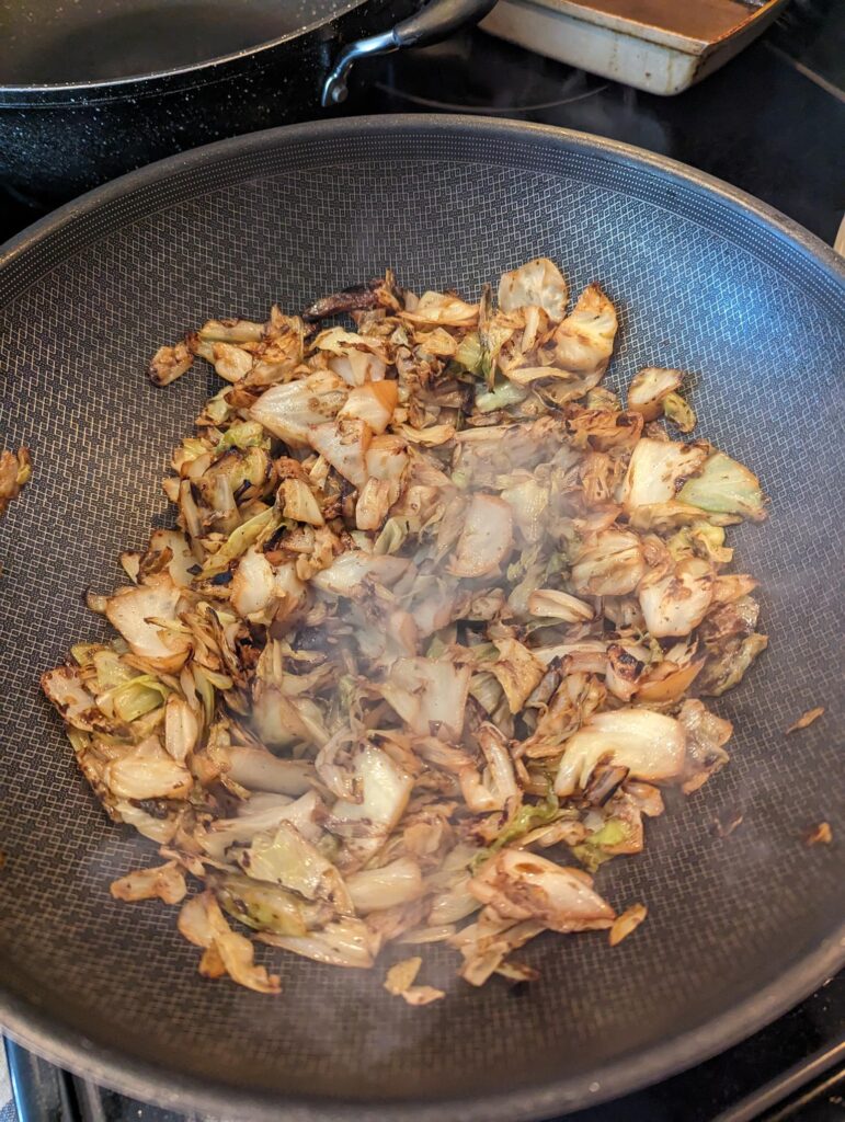 Moist cabbage in a wok.