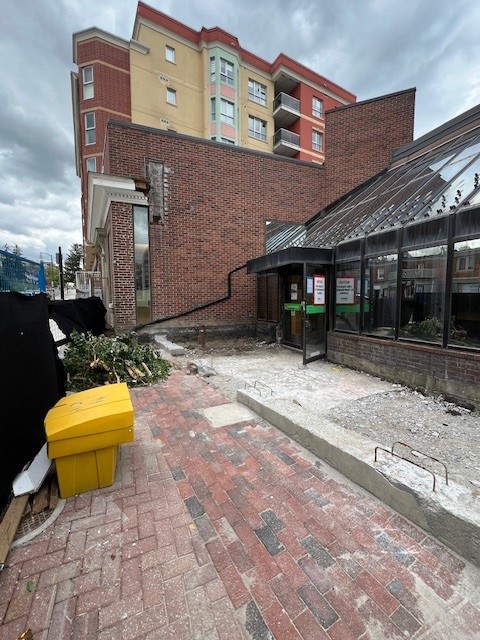 Exterior image of the Woodbridg Library. Brick pillars surrounding the old entrance have all been demolished.