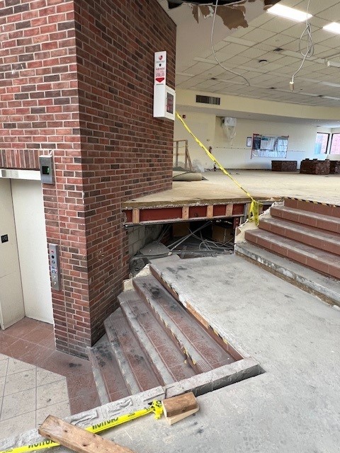Interior image of the library. The old mezzanine area is under demolition and the staircase will be relocated.