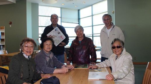 Group of seniors reads at the library