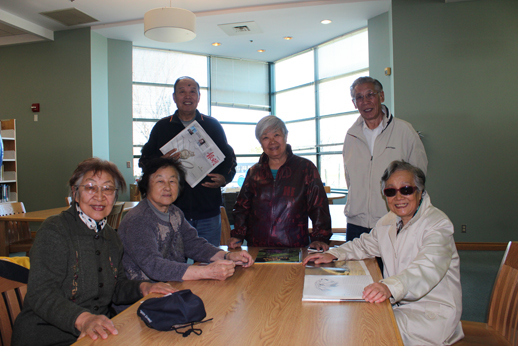 Group of seniors reads at the library